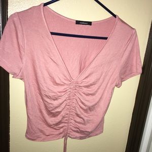 pink crop top.